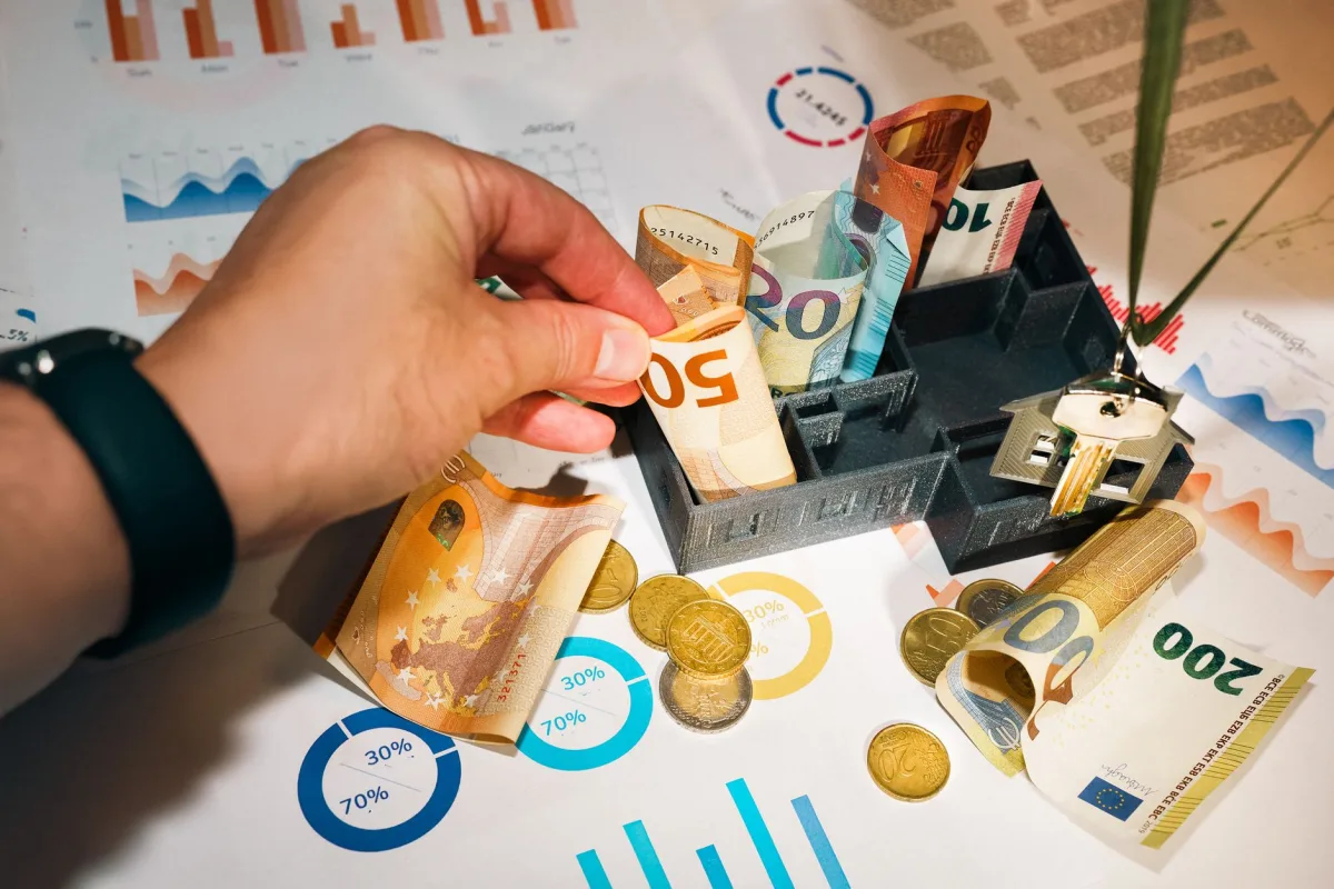 Euro bills and coins with charts showcasing budgeting and investment planning.
