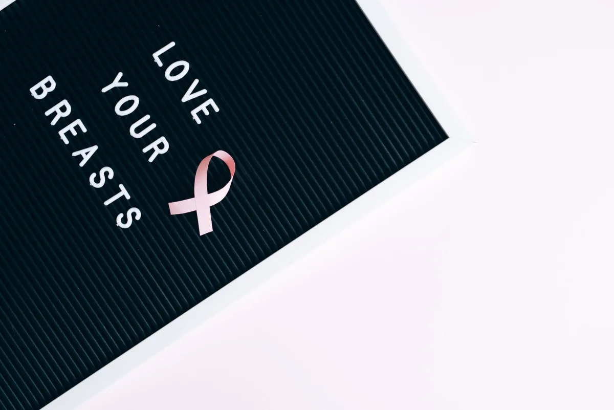Inspirational letter board with pink ribbon promoting cancer awareness and self-love. Inspirational letter board with pink ribbon promoting cancer awareness and self-love.