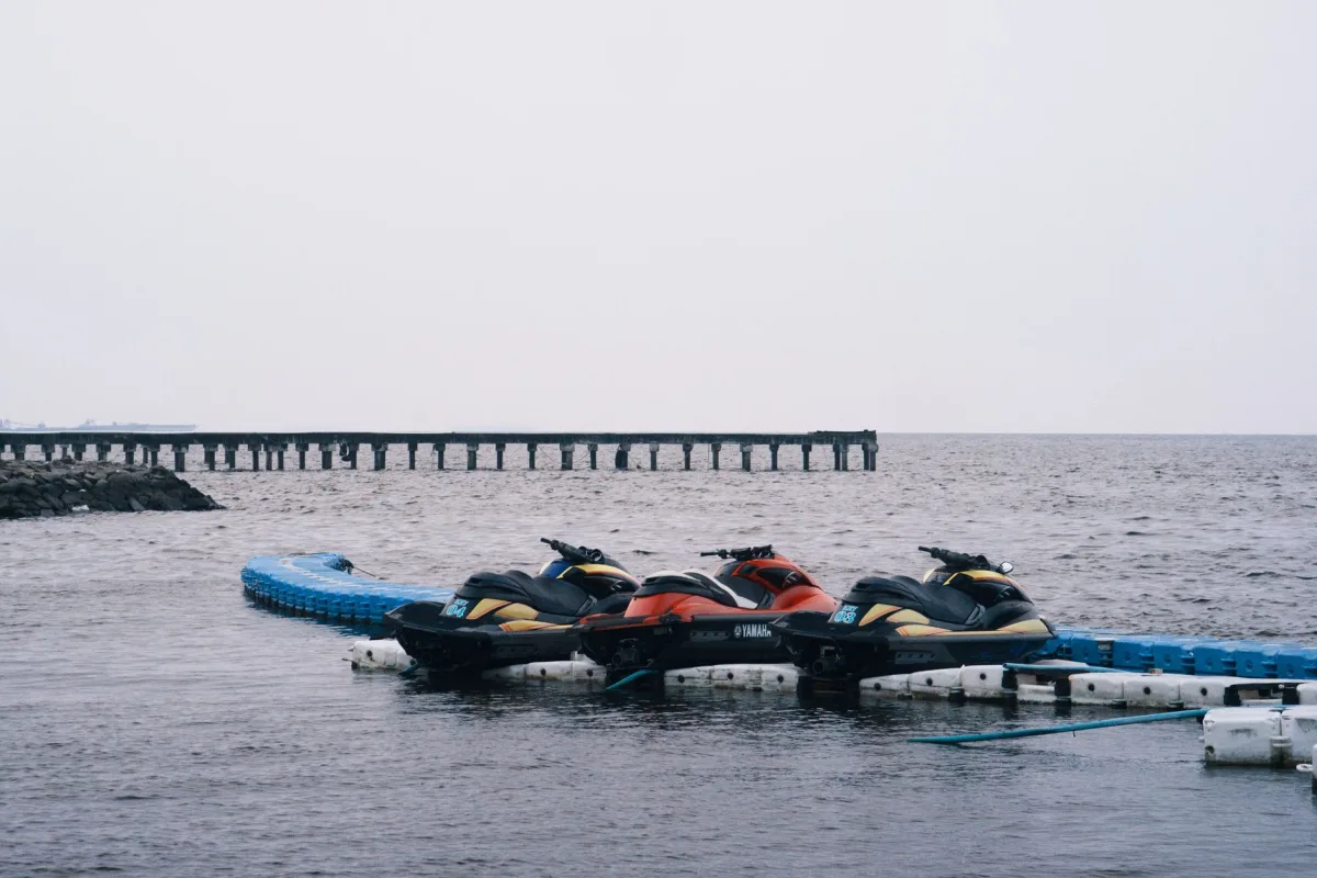 skis docked on a calm day at Jakarta's coastal marina, Indonesia, under an overcast sky. skis docked on a calm day at Jakarta's coastal marina, Indonesia, under an overcast sky.