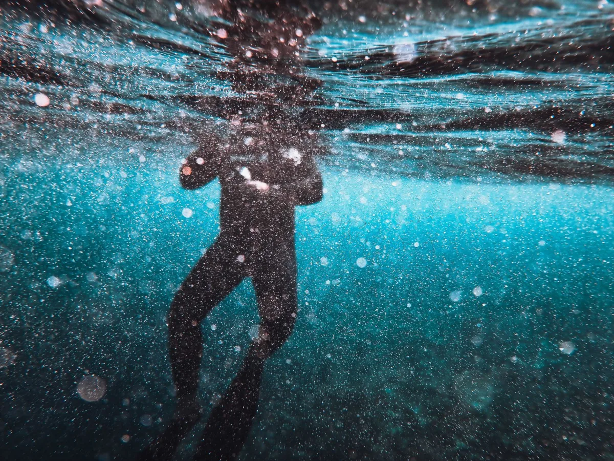 Silhouette of a diver surrounded by bubbles underwater at Farasan Island, Saudi Arabia.